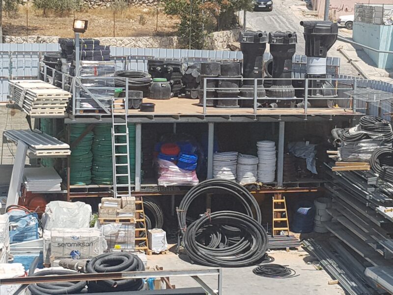 מיכלי ביוב, גלילי כבלים וצינורות בחצר האחסון